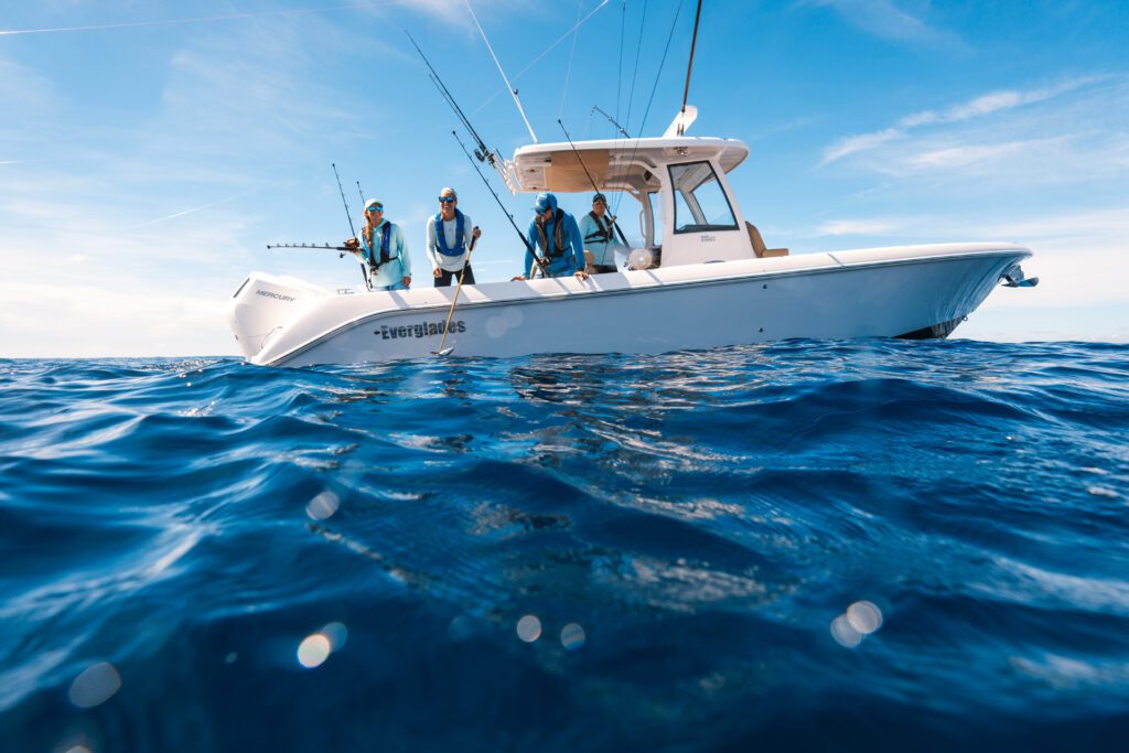 995 Center console everglades fishing boat with men fishing in deep blue water