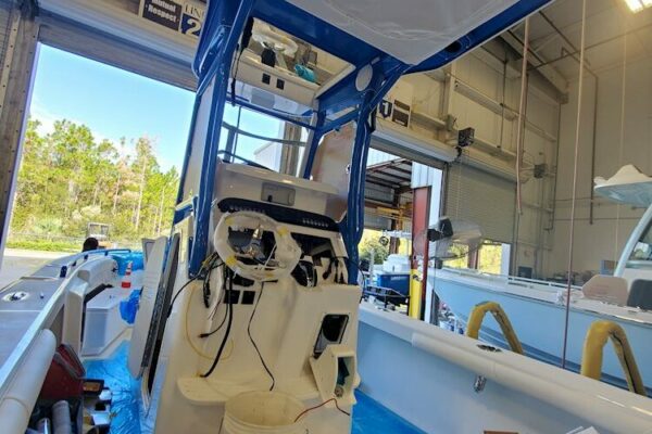 Everglades boat being built with exposed steering and control systems, in a workshop setting