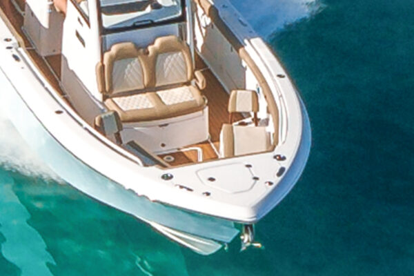 Partial top view of a white Everglades boat on clear blue water