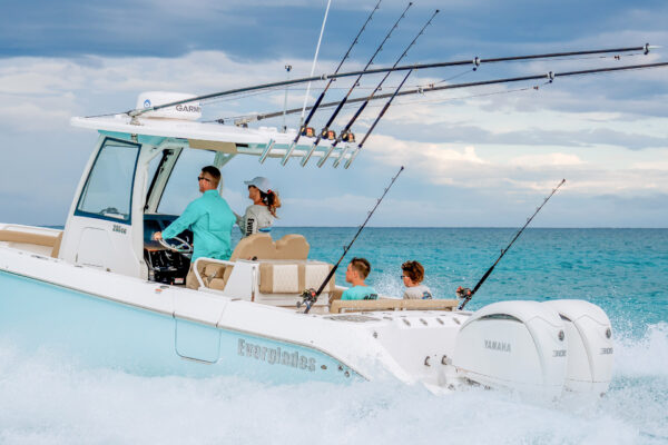 Everglades boat with fishing rods with people onboard