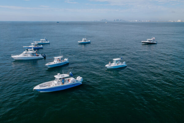 DJI_0518_9182 Group of everglade fishing boats in the water off the coast of a city