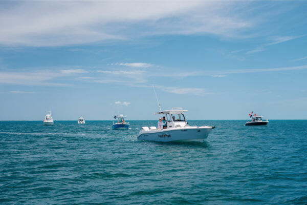 JJS00166_1064 Multiple Everglades boats cruising on the open water under a clear blue sky