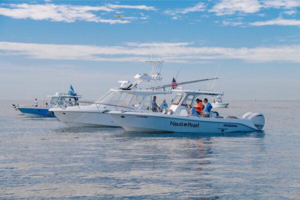 JJS06717_6392 Two Everglades boats are stationary on a calm sea under a clear blue sky
