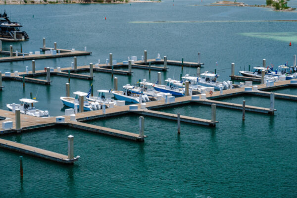 JJS06980_2160 Aerial view of a marina with multiple Everglades boats docked at the piers in calm water