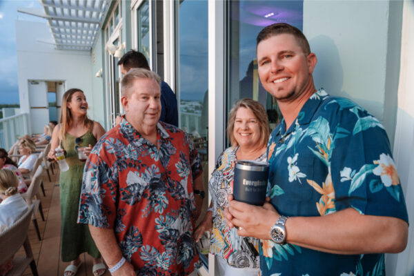 JJS07547_8866 A group of people in floral shirts at a social gathering on a balcony