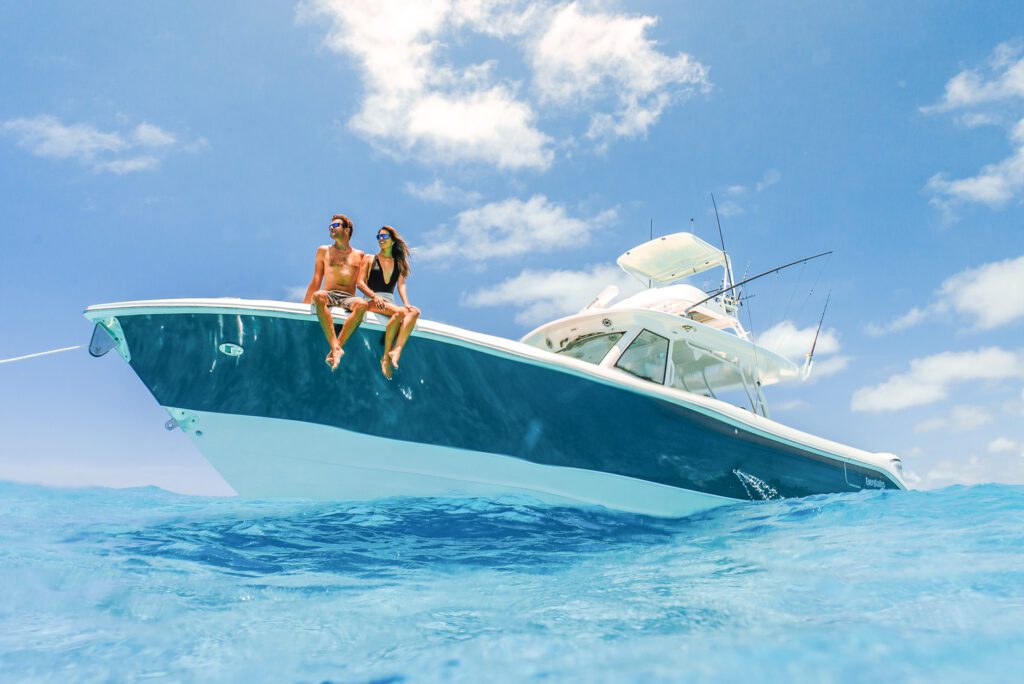 everglades_455cc_lifestyle_DSC05683 Two people sitting on the bow of an everglades fishing boat in water on a sunny day