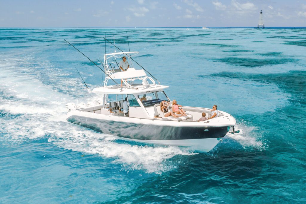 everglades_455cc_running_DJI_0080 Hybrid boat with people riding on the boat driving through blue water