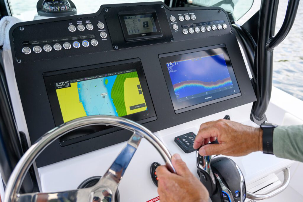 253-controls a hybrid Everglades boat, with a navigation system and depth finder displayed on the dashboard