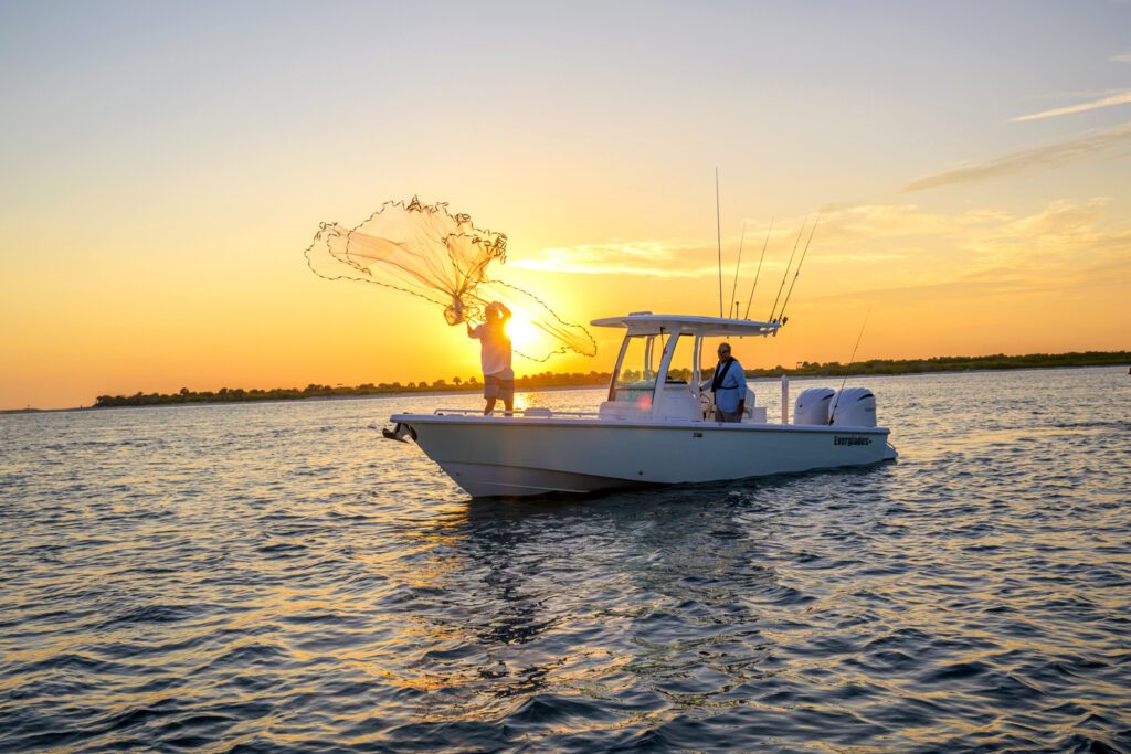 273-netting Casting a large fishing net off a center console everglades boat at sunset