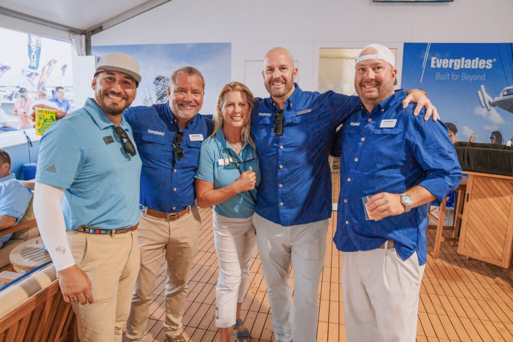 JJS02691-edit The Everglades team staff, wearing blue company shirts, smiling and posing together